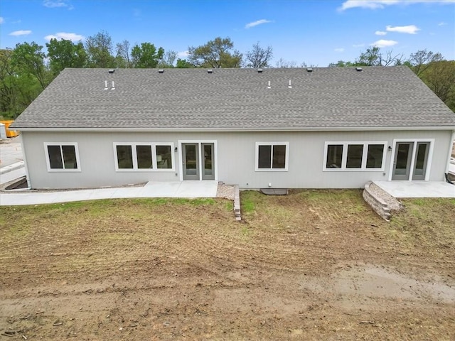 back of house featuring a patio and a shingled roof