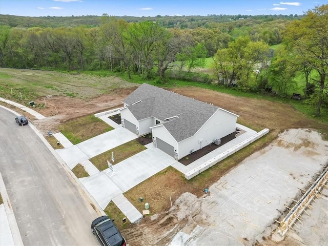 aerial view featuring a wooded view