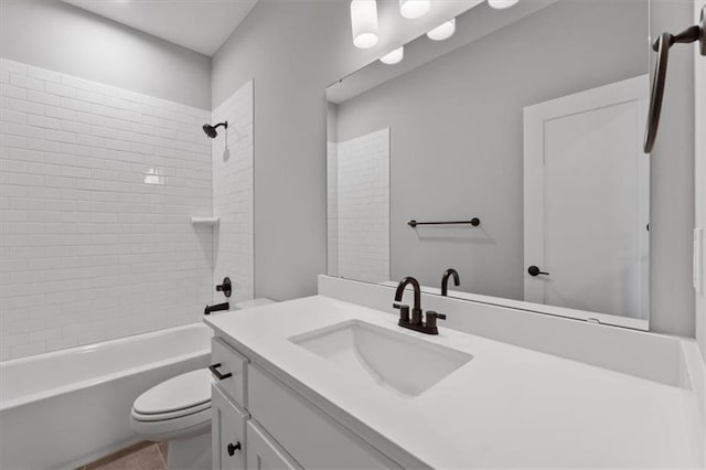 full bathroom featuring toilet, vanity, tile patterned flooring, and tiled shower / bath combo