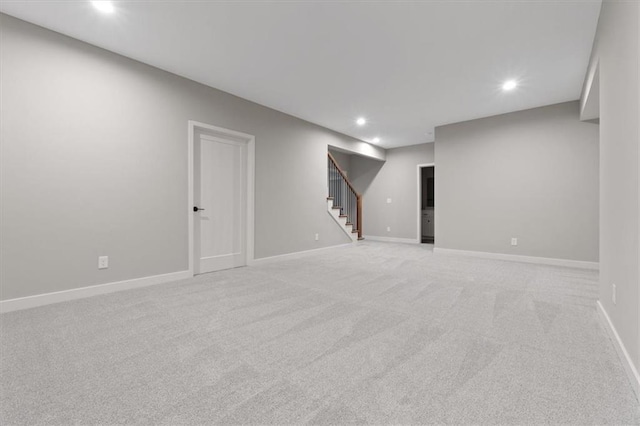 basement featuring light colored carpet