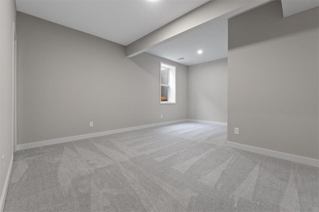 basement featuring light carpet