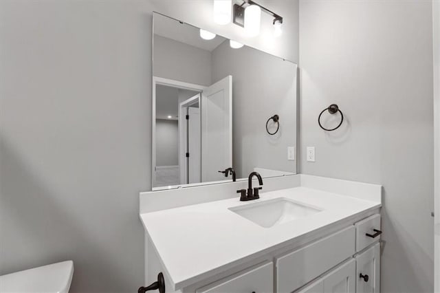 bathroom featuring toilet and vanity