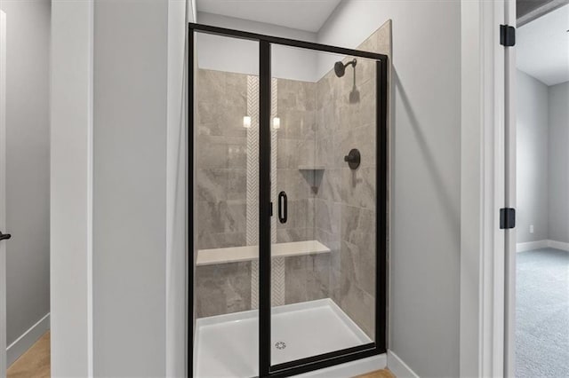 bathroom featuring a shower with shower door