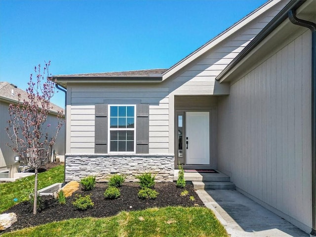 entrance to property with stone siding