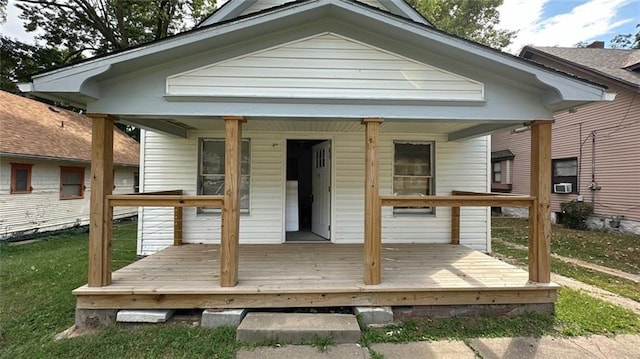 rear view of house with cooling unit and covered porch