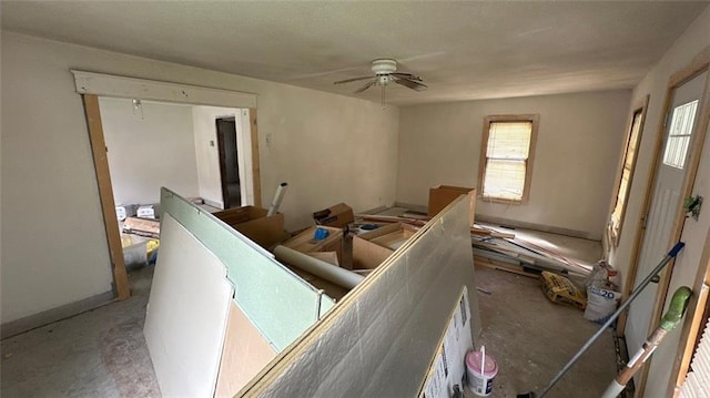 living room with ceiling fan and concrete floors