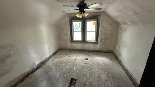 bonus room with ceiling fan, hardwood / wood-style flooring, and vaulted ceiling