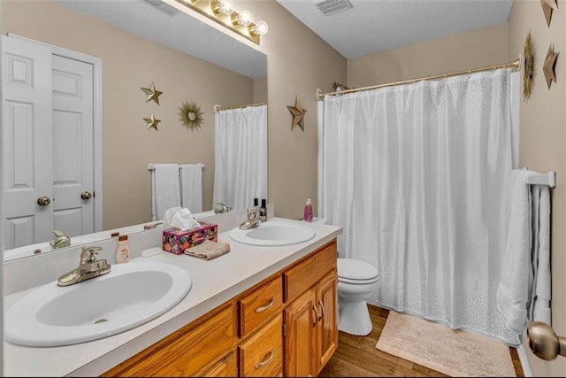 bathroom with vanity, curtained shower, toilet, and wood-type flooring