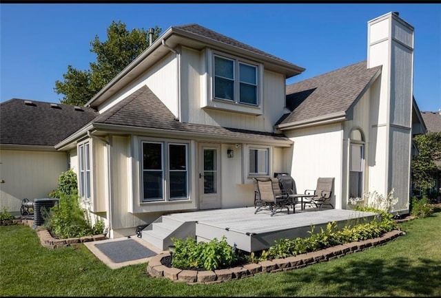 back of house with a lawn, a wooden deck, and central AC