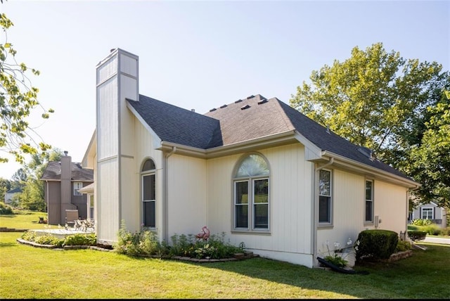 view of property exterior with a lawn