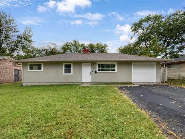 single story home featuring a garage and a front lawn