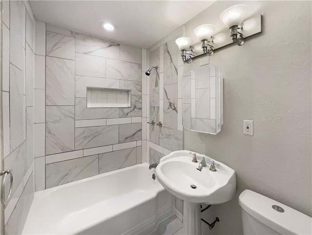 full bathroom with toilet, sink, and tiled shower / bath