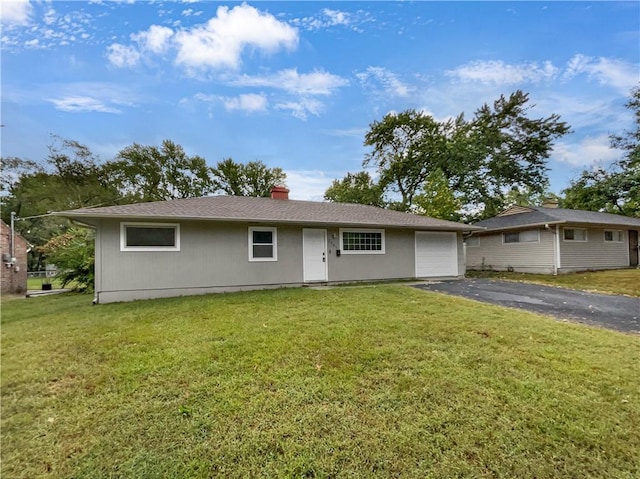 ranch-style house with a garage and a front yard