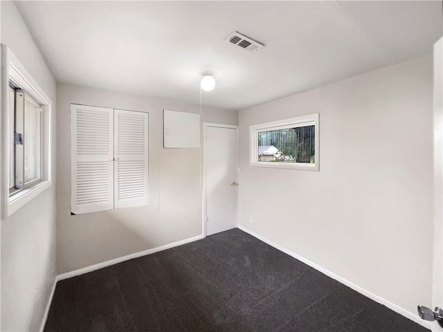 unfurnished bedroom with carpet and a closet