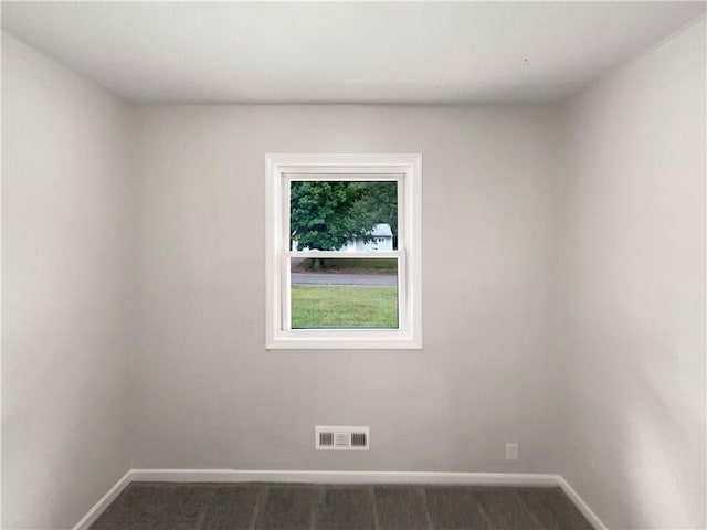 spare room featuring dark hardwood / wood-style floors