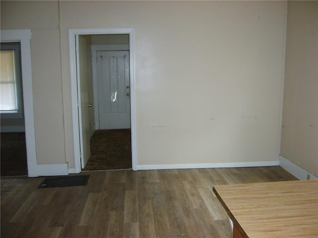 spare room with wood-type flooring