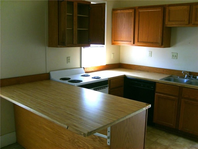 kitchen featuring black dishwasher, sink, kitchen peninsula, and range