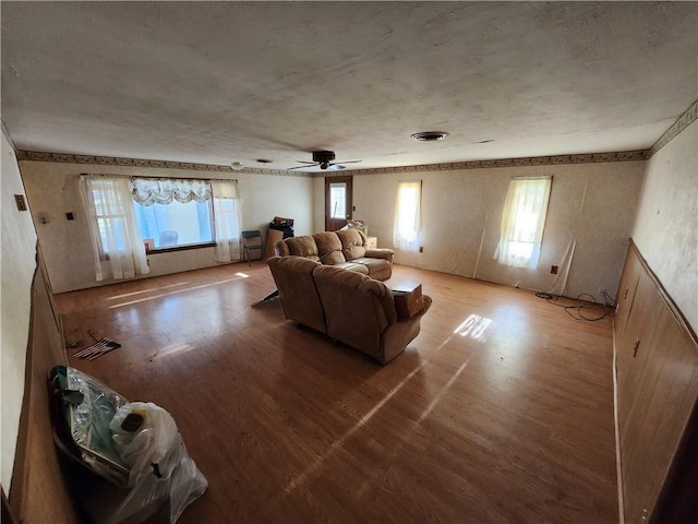 living room with hardwood / wood-style floors and ceiling fan