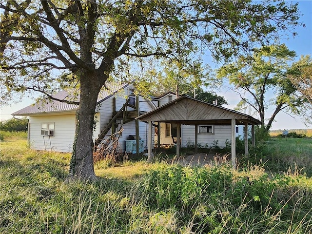 rear view of property with cooling unit and a porch