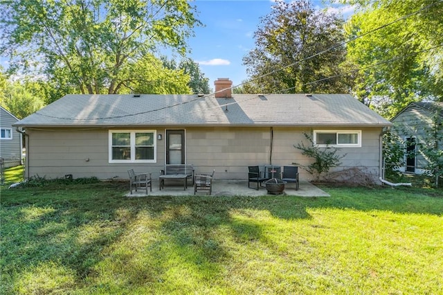 rear view of house featuring a yard and a patio area