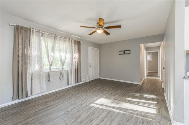 spare room with ceiling fan and dark hardwood / wood-style flooring