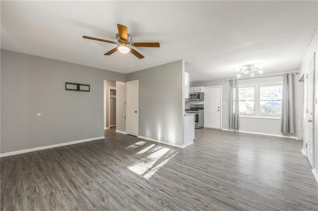 unfurnished living room featuring ceiling fan and dark hardwood / wood-style floors