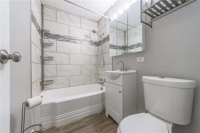 full bathroom with tiled shower / bath, vanity, toilet, and hardwood / wood-style flooring