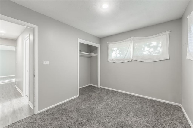 unfurnished bedroom featuring carpet floors and a closet