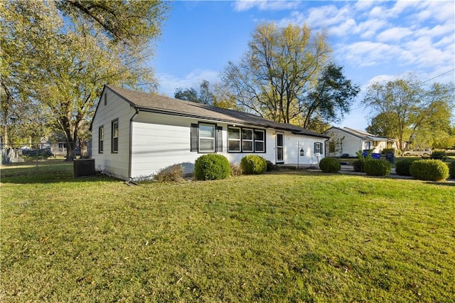 ranch-style house featuring a front yard and central AC