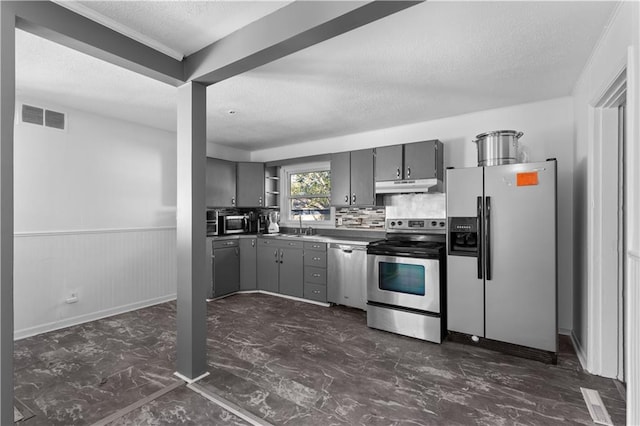 kitchen with gray cabinets, tasteful backsplash, sink, and stainless steel appliances