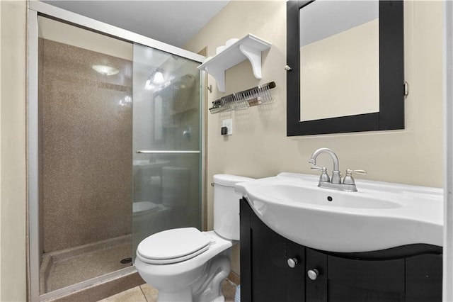 bathroom with toilet, vanity, tile patterned flooring, and walk in shower