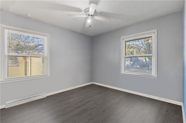 spare room with ceiling fan, baseboard heating, dark hardwood / wood-style floors, and a textured ceiling