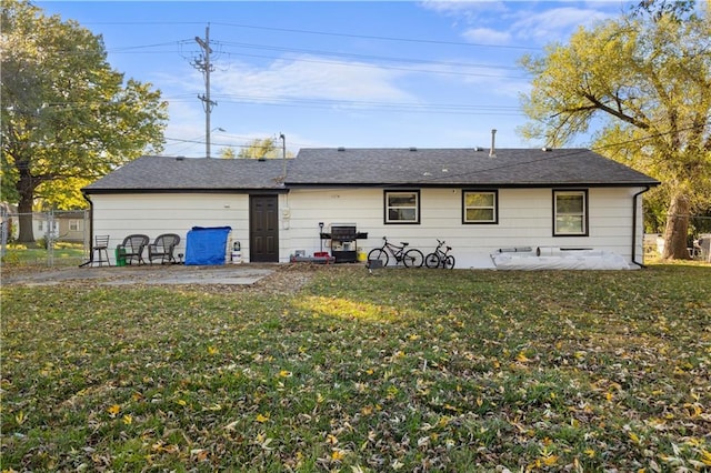 rear view of property with a yard