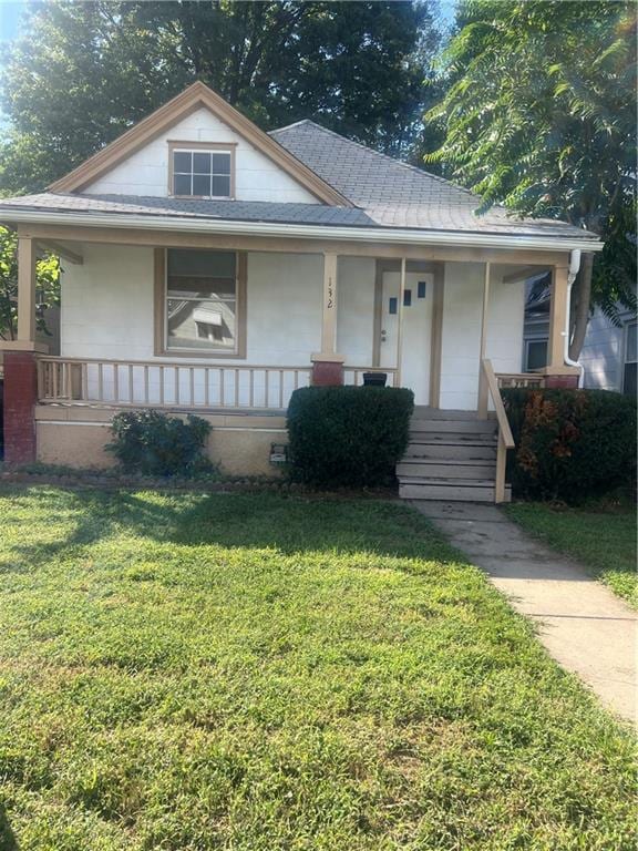 bungalow-style house featuring a front lawn and a porch