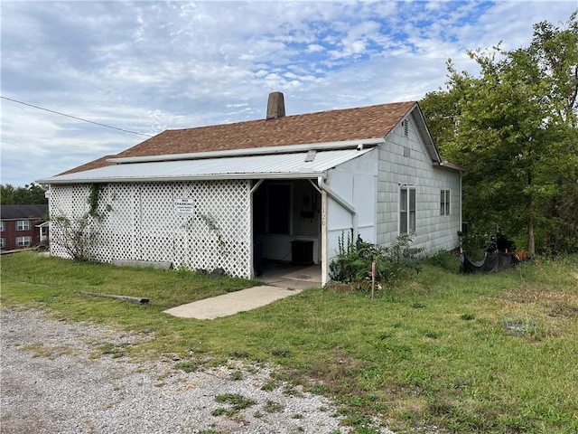 rear view of house with a yard