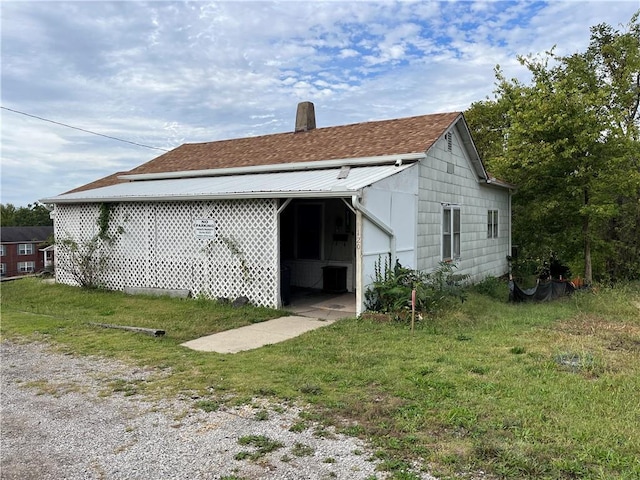 120 N Main St, Warrensburg, MO 64093 - rear view of property featuring a lawn and a chimney