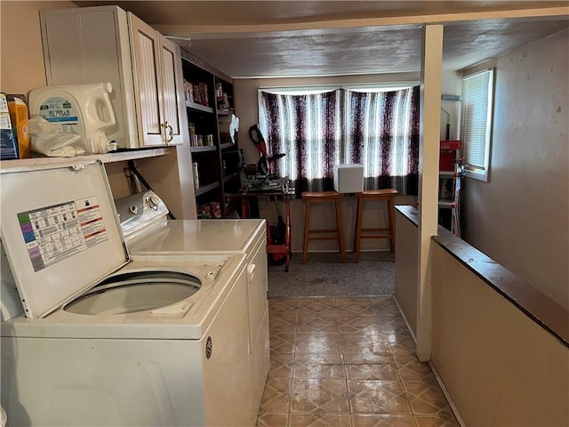 washroom with cabinets and independent washer and dryer