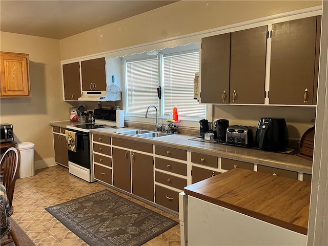 kitchen with white electric range and sink