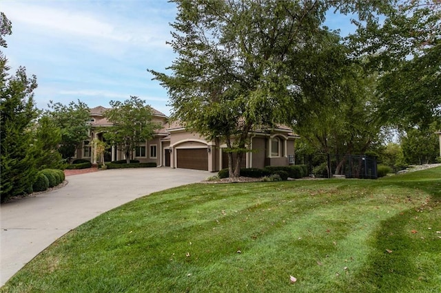 view of front of house with a garage and a front yard