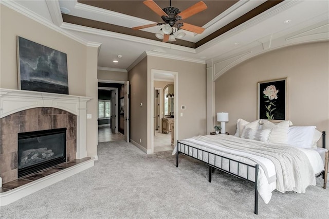 carpeted bedroom featuring ceiling fan, a fireplace, and ornamental molding