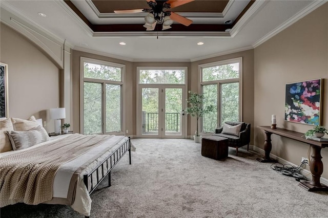 bedroom with ceiling fan, a raised ceiling, carpet flooring, and crown molding