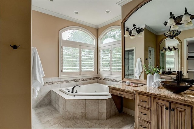 bathroom featuring crown molding, tile patterned flooring, vanity, and a relaxing tiled tub