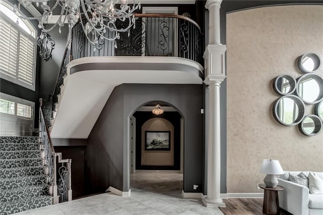 interior space with ornate columns, a chandelier, and a wealth of natural light