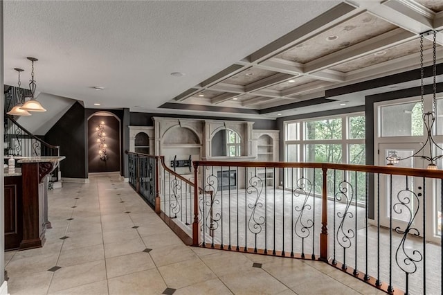 hallway with a textured ceiling, beam ceiling, coffered ceiling, and light tile patterned floors