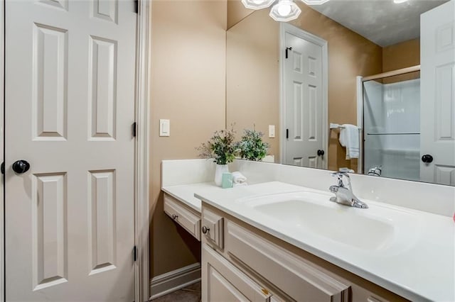 bathroom featuring vanity and a shower with shower door