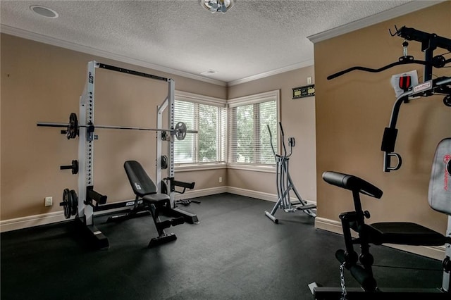 workout area featuring ornamental molding and a textured ceiling