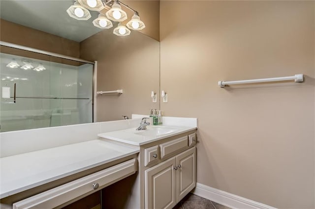 bathroom with walk in shower, vanity, and tile patterned flooring