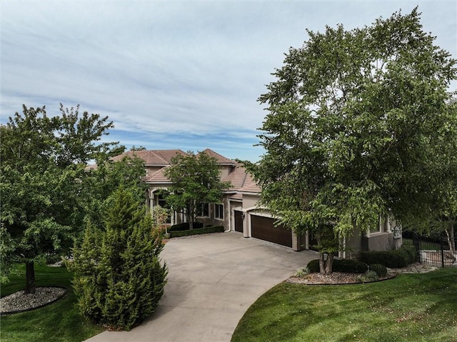 view of front facade featuring a front yard and a garage