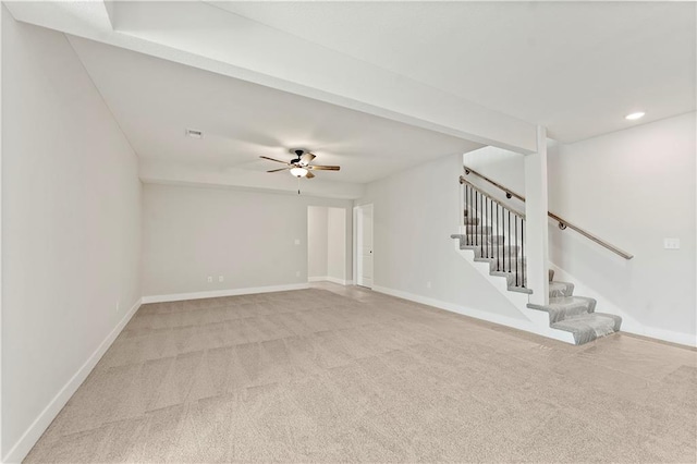 unfurnished living room featuring stairs, light carpet, and baseboards