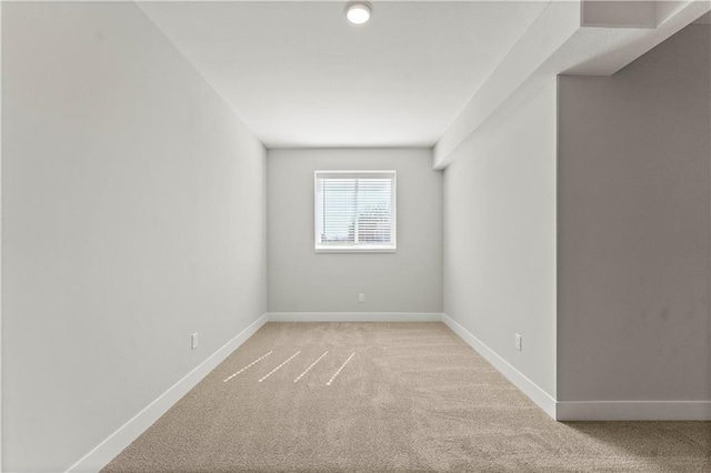 unfurnished room with light carpet and baseboards